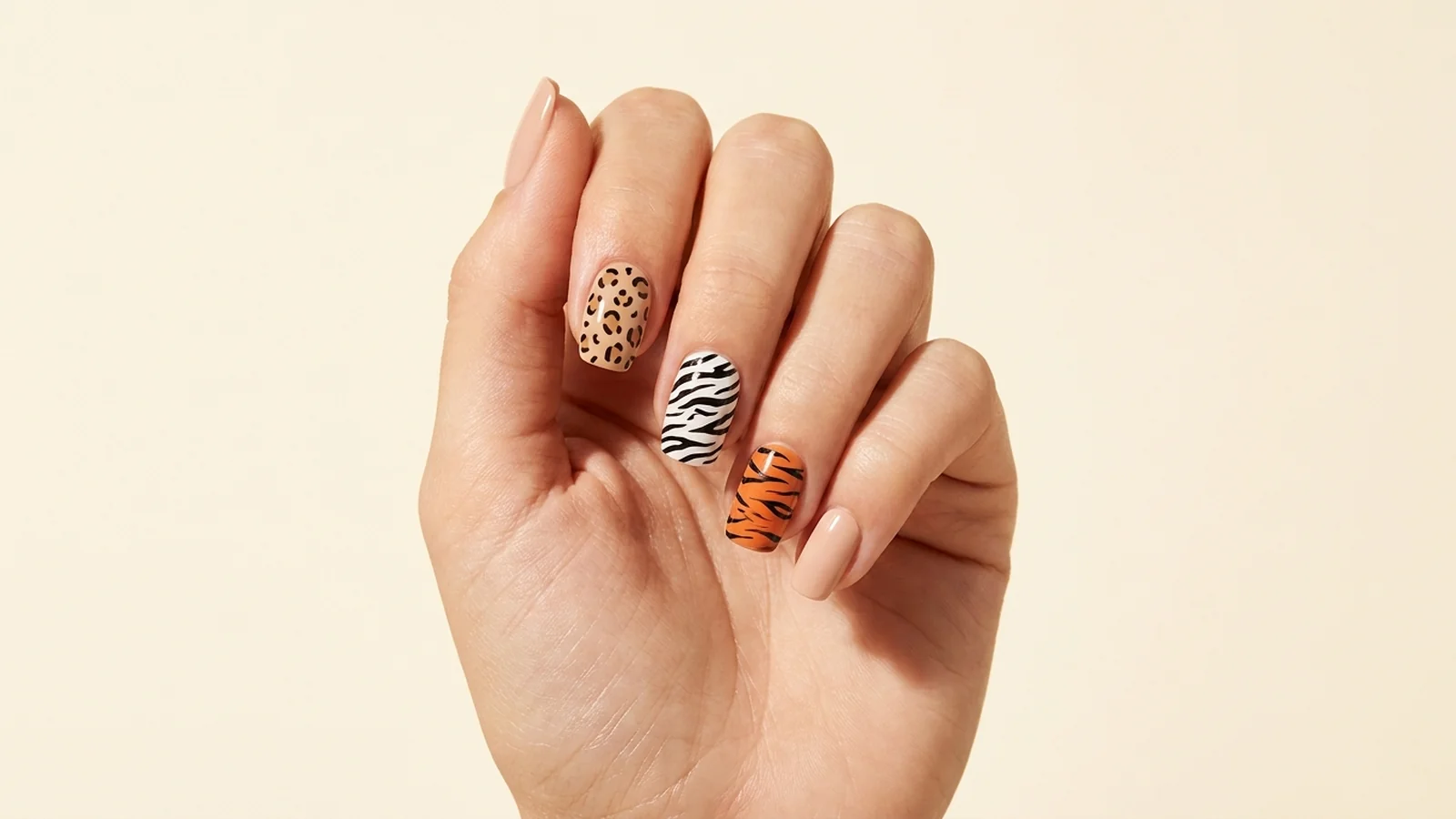 Nude manicure with leopard, zebra and tiger-print accent nails